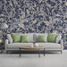 Traditional damask navy wall covering in a cozy, well-lit reading nook