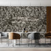 Damask mural wallpaper installed behind a cozy reading chair in a meeting room
