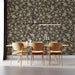 A traditional office featuring a brown and cream damask mural backdrop with dark wood furniture.