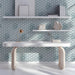 A bright study featuring the Seigaiha wave wallpaper behind a bed.