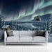A relaxing living room corner with a sweeping snowy forest and northern lights feature wall mural.