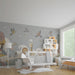 Nursery room wall featuring cute safari animal wallpaper in soft muted tones.