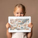 A bright child's bedroom with a celestial animal wall mural above a twin bed and wooden desk.