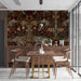 Moody dining room with Victorian peacock wallpaper, dark wooden table, and brass lighting