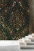 Sophisticated library featuring a dark green botanical damask mural wallpaper behind vintage bookshelves