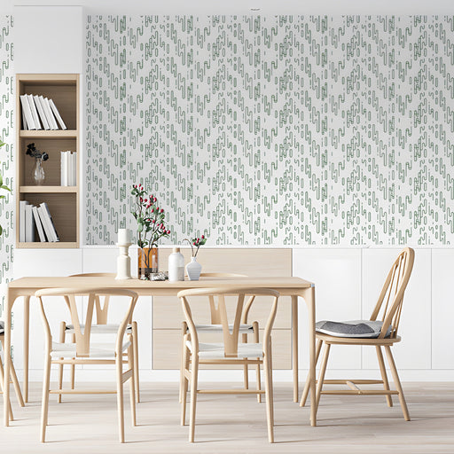 Modern dining room with sage green geometric line art wallpaper on the feature wall behind a wooden desk