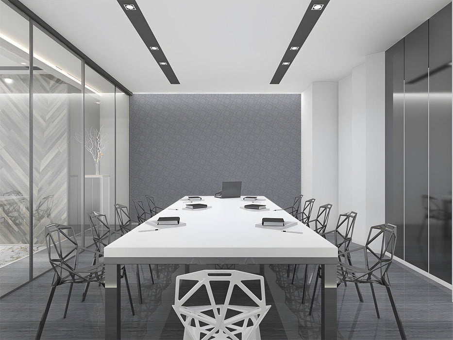 Modern office with grey geometric circle wallpaper on the accent wall behind a wooden desk