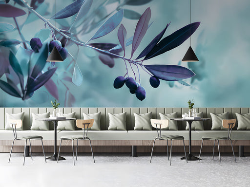 Modern bar featuring a serene olive branch mural behind a gray velvet sofa