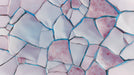 Geometric wallpaper pattern with pale rose and lilac porcelain shards separated by bright blue electric fissures