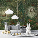 A cozy nursery room wall covered in a woodland animal mural with soft lighting.