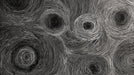 Abstract wallpaper pattern featuring hand-drawn white concentric circles on a black background