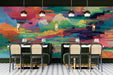 Restaurant featuring colorful glitch landscape wall mural behind a minimalist beige sofa