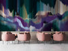 Glitch art mural installed behind a modern minimalist sofa in a moody cafe.