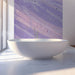 Lilac brushstroke mural behind a cozy bed in a modern bathroom
