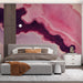 Stylish bedroom space with an expressive fluid art mural in shades of pink and deep purple