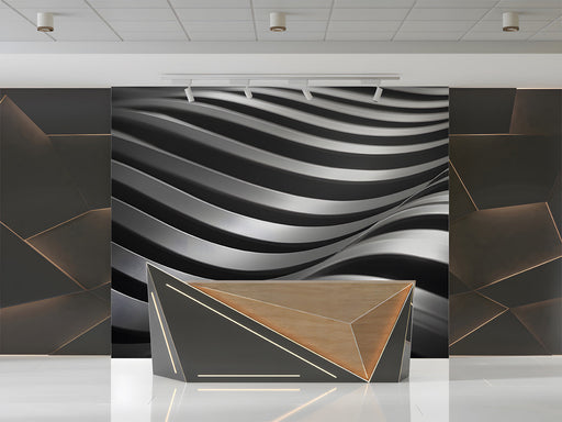 A sleek modern office wall featuring an abstract charcoal wave mural behind a glass desk.