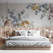 A cozy, light-filled bedroom area featuring a neutral ginkgo and eucalyptus wall mural that complements wood textures.