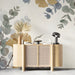 A bright entryway wall featuring a delicate botanical ginkgo and eucalyptus mural as a soft headboard feature.