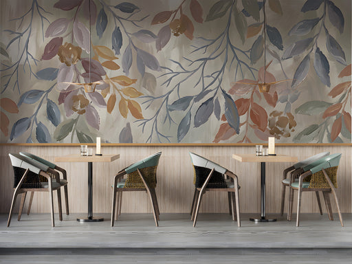 Painterly leaf mural wallpaper installed behind a cozy reading chair in a modern bar
