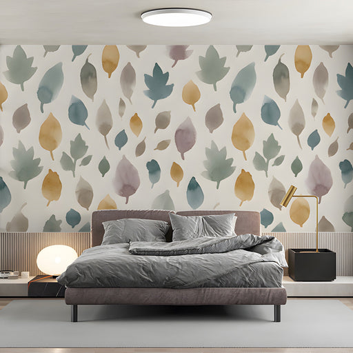 Soft watercolor leaf mural installed as an accent wall in a cozy bedroom with wooden furniture