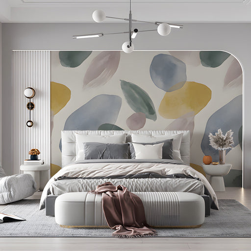 Watercolor leaf wall mural installed in a light-filled living room with linen sofa and oak coffee table.