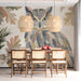 An elegant dining room corner featuring a whimsical forest collage mural with owl and ferns.