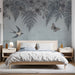 A calming bedroom with a soft blue floral and bird wallpaper accent wall