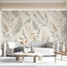 Cozy living room wall covered in a light watercolor fern and lavender mural with neutral bedding