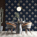 A sophisticated dining room wall covered in dark blue damask wallpaper with wooden accents