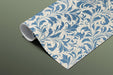 A formal dining room with blue and cream botanical wallpaper and dark wood furniture.