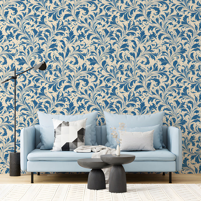 A living room featuring heritage blue leaf wallpaper behind a velvet sofa.