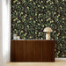 A sophisticated bedroom featuring olive leaf wallpaper and mid-century modern furniture.