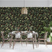 A cozy dining room with olive branch patterned wallpaper and dark oak bookshelves.