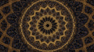 Intricate golden mandala pattern on a deep charcoal background with filigree motifs