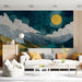 living room wall decorated with a whimsical starry night and mountain landscape wallpaper