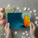 Reading nook featuring an expressive cat wall mural and a velvet armchair