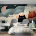Dreamy illustration wallpaper featured in a small reading nook with a velvet armchair.