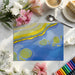 Bright home office space featuring an abstract topographic wall covering with blue and yellow tones