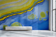Modern hallway with a vibrant blue and yellow fluid art mural on the main feature wall