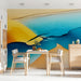 Dining room interior featuring an abstract blue and gold mural on the main feature wall behind a minimalist sofa.