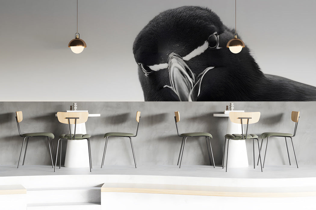 Minimalist bar with a large black and white bird mural behind the headboard