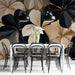 Modern meeting room featuring a monochromatic floral wall mural behind a velvet headboard