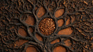 Close up of charcoal gnarled roots over a burnt copper background with an amber stone center