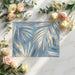 Bedroom wall covered in blue and gold palm leaf mural with white bedding