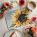 A calming bedroom interior with a watercolor sunflower mural accent wall and white linen bedding.