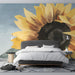 A bright bedroom space decorated with a bold sunflower mural mural, highlighting its painterly textures.