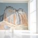 A cozy  entryway featuring the desert canyon mural as a statement wall behind a minimalist sofa.
