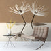 Modern entryway wall featuring the dandelion mural behind a low wooden bed frame and neutral bedding.