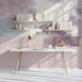 Cloud mural installed as a calming feature wall in a sunlit study with wooden crib and white textiles.
