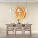 A bright, modern dining room featuring a citrus slice mural behind an island with wooden stools